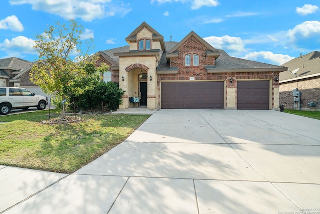 view of front of property with a front yard and a garage