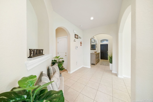 corridor featuring light tile patterned floors