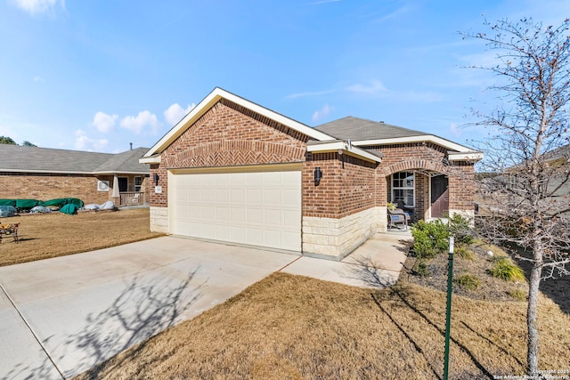 view of front of house featuring a garage and a front lawn