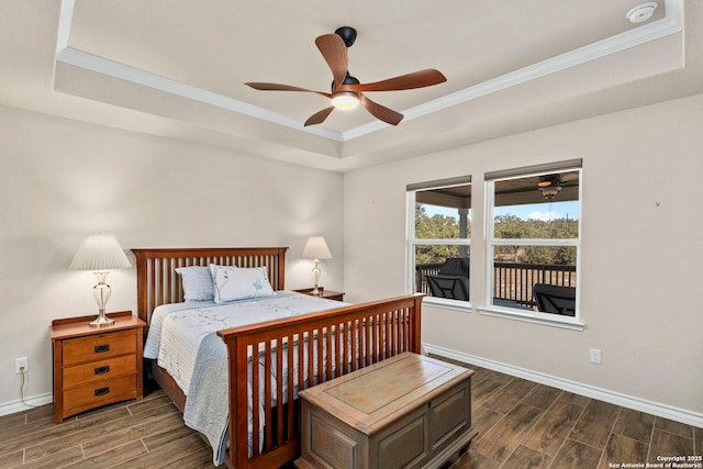 bedroom featuring crown molding, a tray ceiling, and ceiling fan