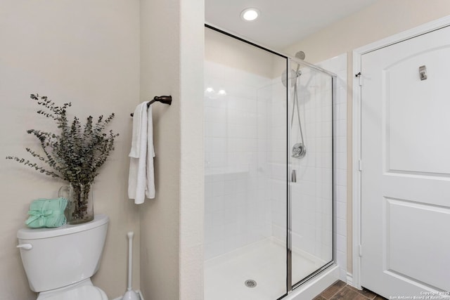 bathroom with walk in shower and toilet