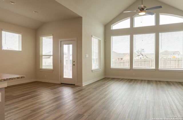 interior space featuring ceiling fan, lofted ceiling, and wood-type flooring