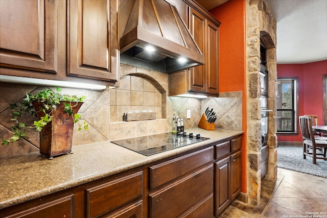 kitchen featuring backsplash, black electric stovetop, extractor fan, and tile patterned flooring