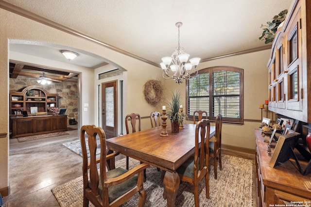 dining room with a chandelier, crown molding, and tile patterned flooring