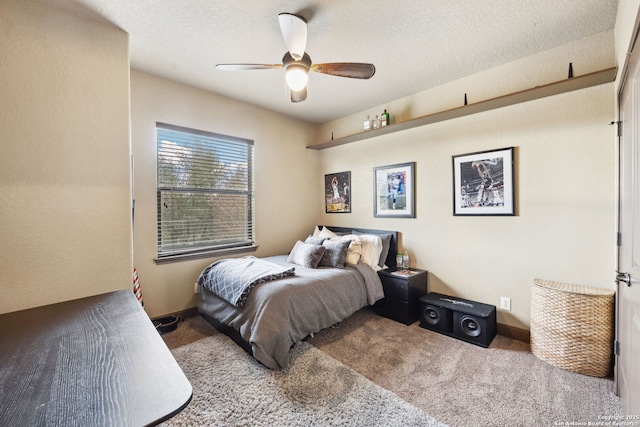 carpeted bedroom with a textured ceiling and ceiling fan