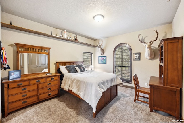 carpeted bedroom with a textured ceiling