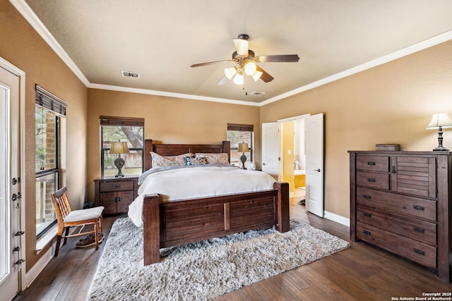 bedroom with crown molding, dark hardwood / wood-style floors, ensuite bath, and ceiling fan