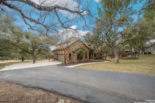 view of front of property with a garage and a front lawn