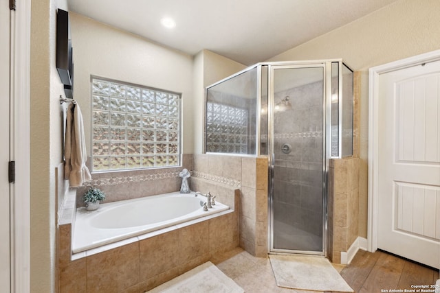 bathroom featuring separate shower and tub and hardwood / wood-style flooring