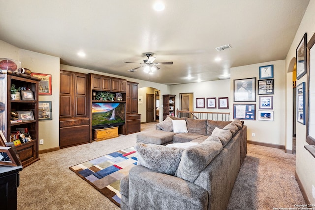 carpeted living room with ceiling fan