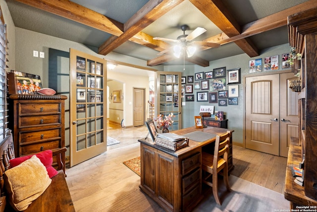 home office with light wood-type flooring, beamed ceiling, ceiling fan, and french doors