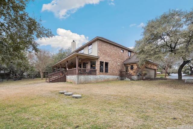 back of house featuring a porch, a garage, and a yard