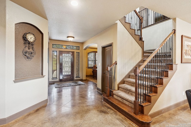 entryway with a textured ceiling