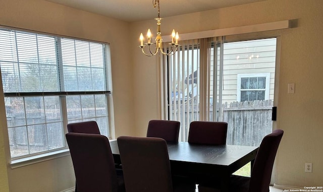 dining area with an inviting chandelier