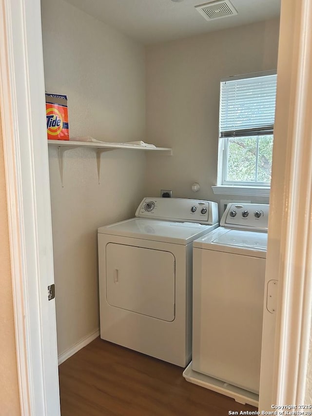 laundry room with dark hardwood / wood-style flooring and washer and dryer