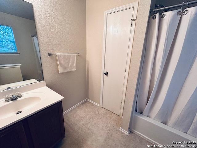 bathroom featuring shower / tub combo with curtain and vanity