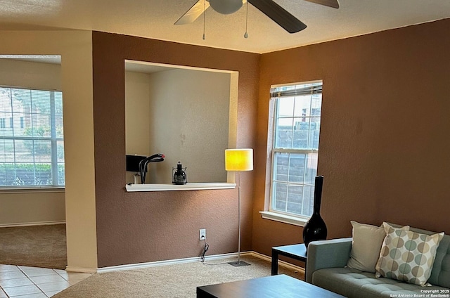 tiled living room featuring ceiling fan