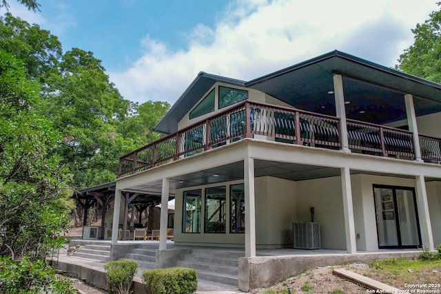 back of property featuring central AC, a patio area, and a balcony