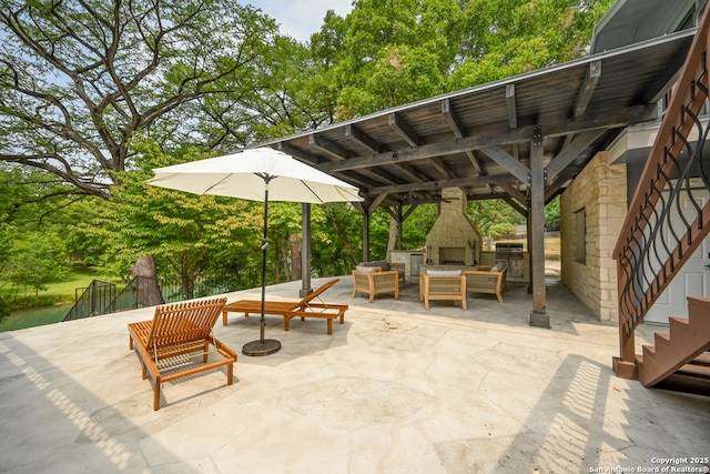 view of patio / terrace with an outdoor living space with a fireplace