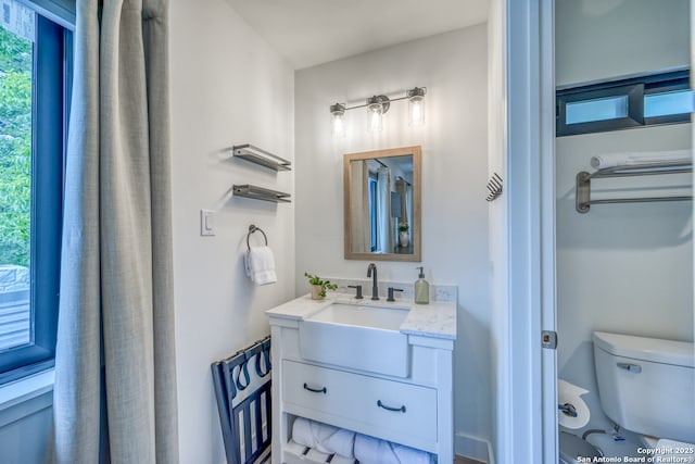 bathroom featuring vanity and toilet