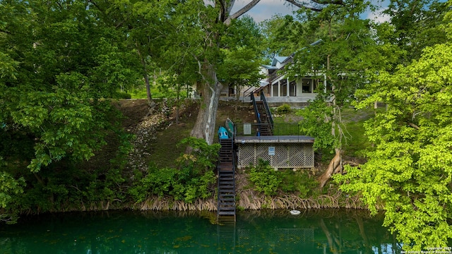 rear view of property featuring a water view