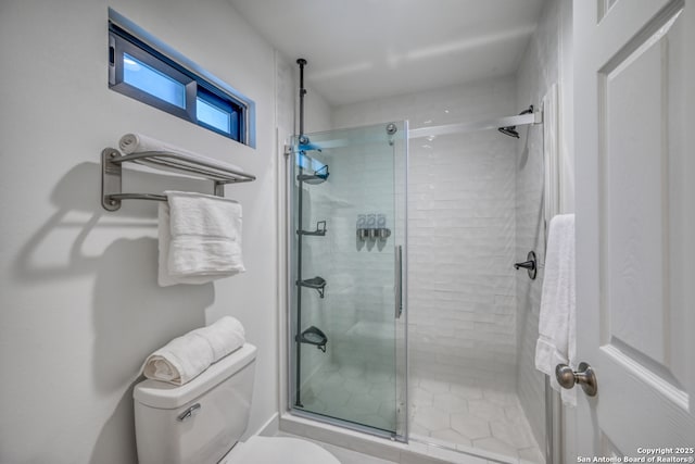 bathroom featuring an enclosed shower and toilet