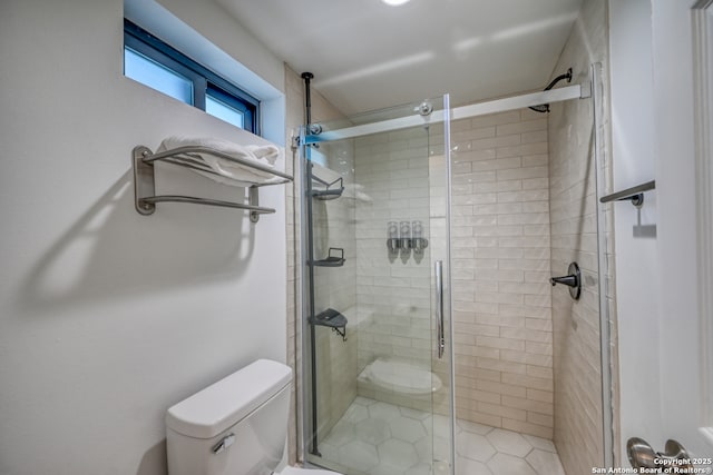 bathroom featuring toilet and walk in shower