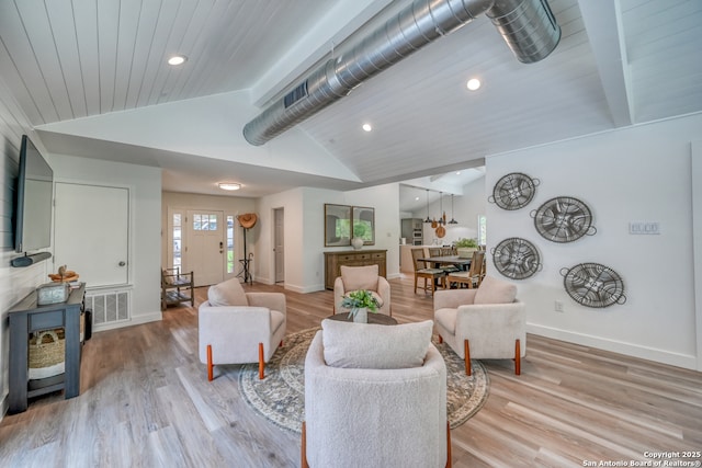 living room with lofted ceiling with beams, wood ceiling, and light wood-type flooring