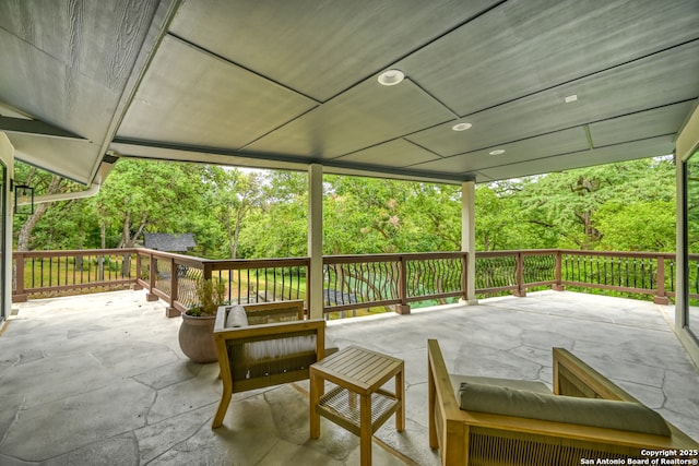 wooden deck featuring an outdoor living space and a patio