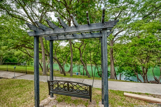 view of community featuring a yard and a pergola