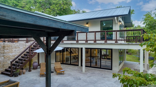 rear view of property featuring a patio