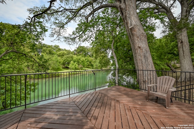 wooden deck featuring a water view