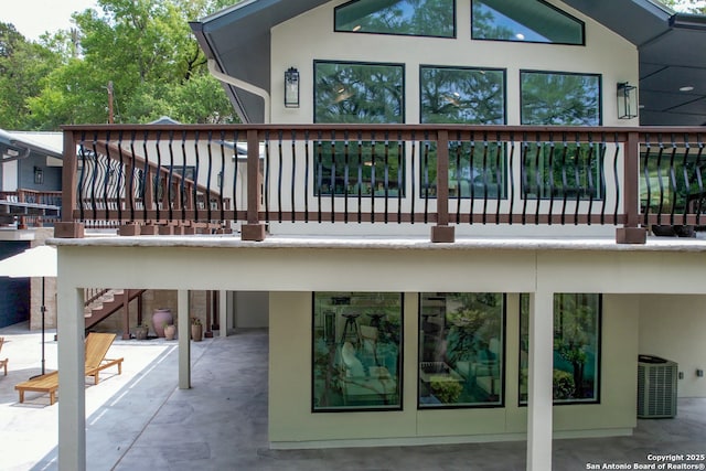 back of house with central AC unit and a patio