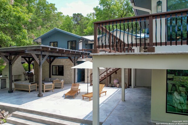 rear view of property with a patio and outdoor lounge area