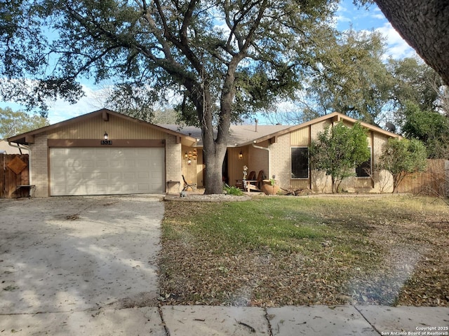 ranch-style home with a garage and a front yard