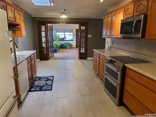 kitchen with sink, french doors, and appliances with stainless steel finishes