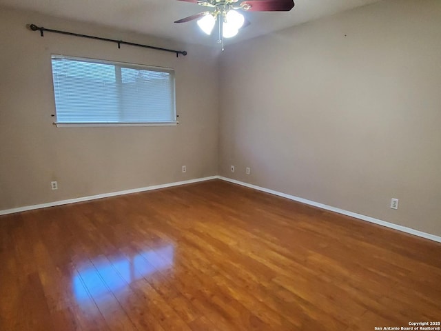 spare room with hardwood / wood-style flooring and ceiling fan