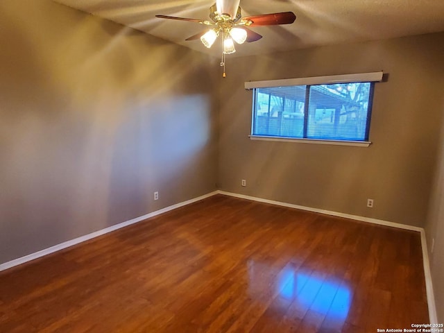 empty room featuring hardwood / wood-style floors and ceiling fan