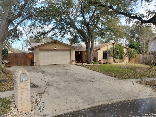 single story home with a garage and a front lawn