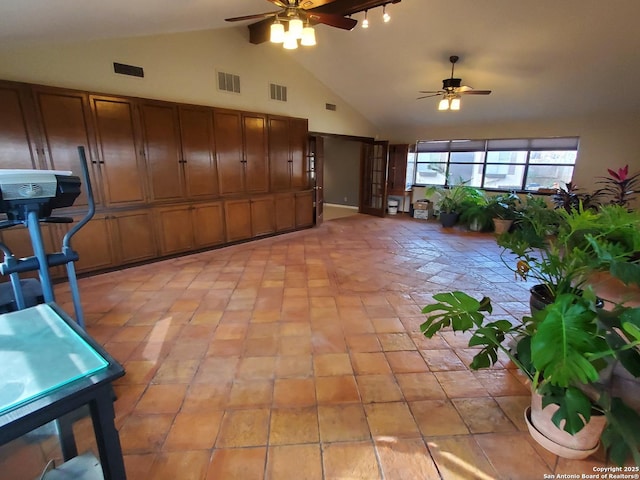 interior space featuring light tile patterned floors, high vaulted ceiling, and ceiling fan