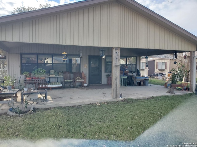 back of house with a yard and a patio area