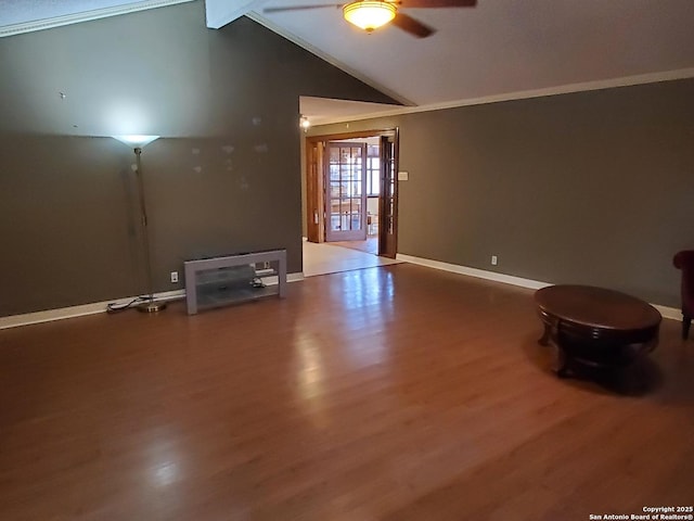 spare room with lofted ceiling with beams, hardwood / wood-style flooring, and ceiling fan