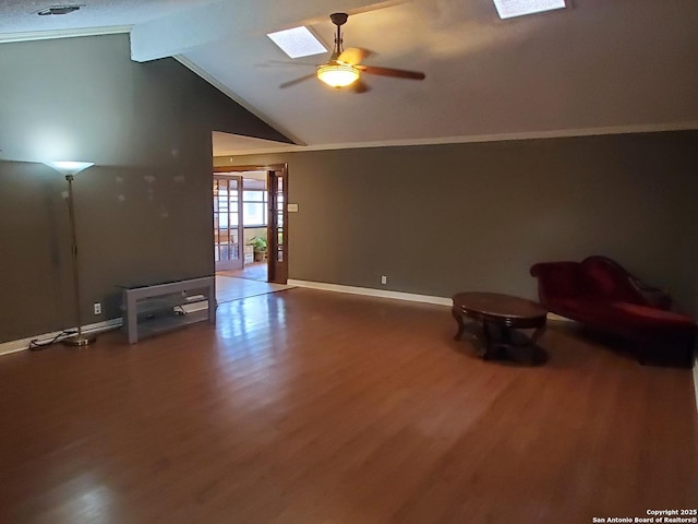 unfurnished living room with wood-type flooring, lofted ceiling with skylight, and ceiling fan