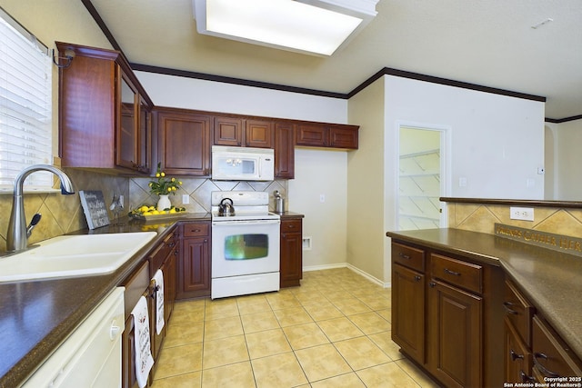 kitchen featuring crown molding, sink, backsplash, light tile patterned floors, and white appliances