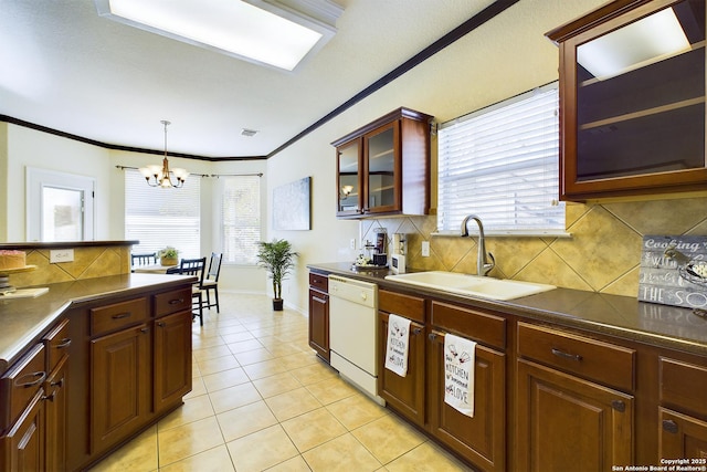 kitchen with pendant lighting, dishwasher, tasteful backsplash, sink, and light tile patterned flooring