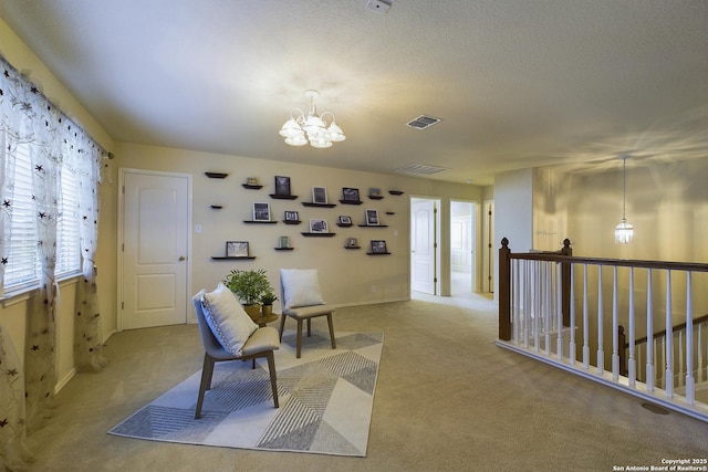 sitting room featuring light colored carpet and an inviting chandelier