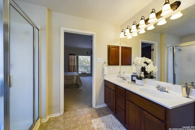 bathroom with vanity, a shower with shower door, and tile patterned floors