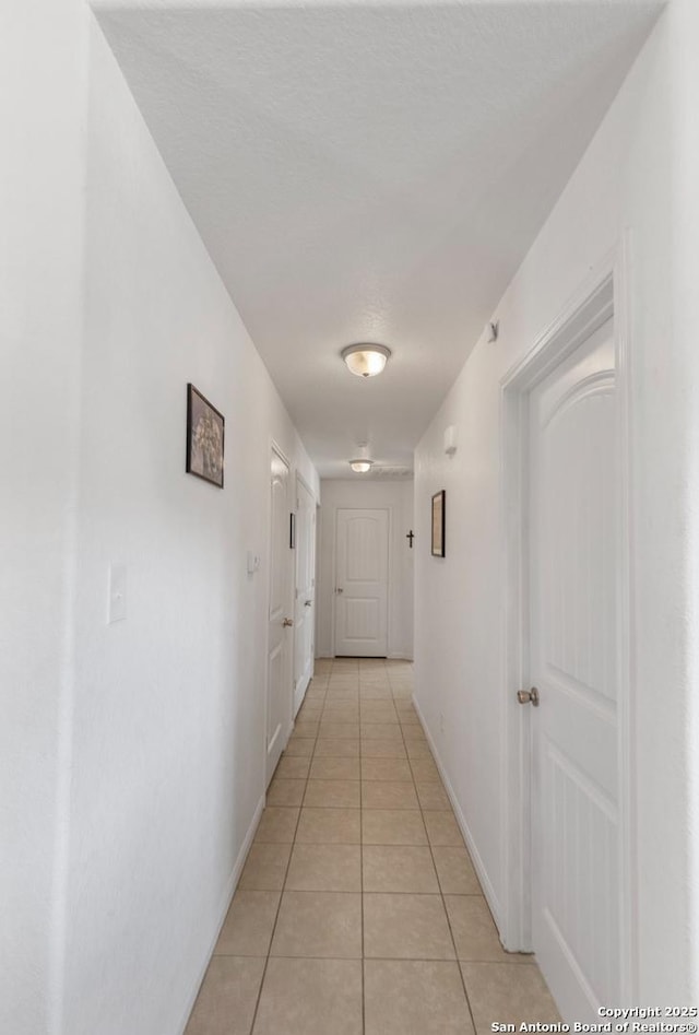 hallway featuring light tile patterned flooring