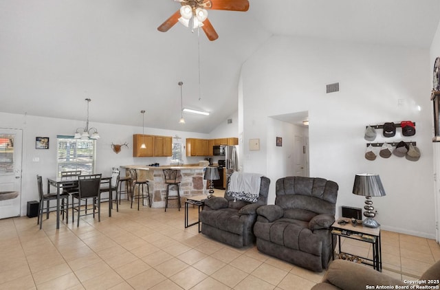 tiled living room featuring high vaulted ceiling and ceiling fan