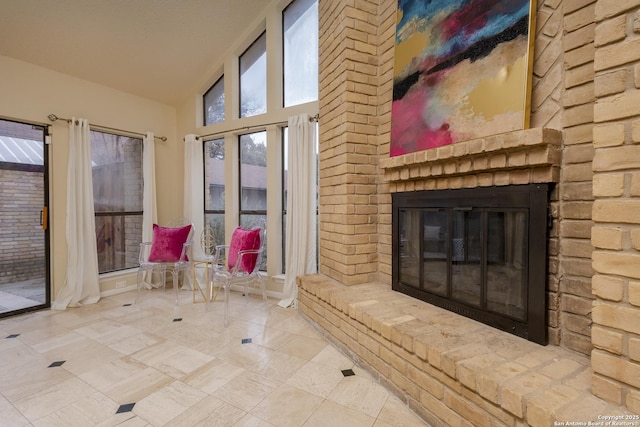 interior space featuring high vaulted ceiling and a fireplace